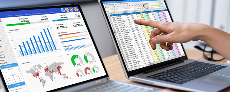 Analyst reviewing industry reports in an Excel sheet and a dashboard